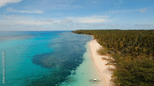 Aerial view of beautiful tropical island Daco with white sand beach. View of a nice tropical beach from the air. Beautiful sky, sea, resort. Seascape: Ocean and beautiful beach paradise. Philippines © Alex Traveler