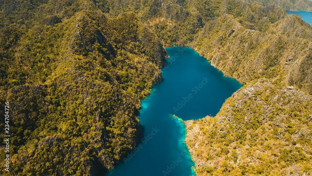 Aerial view:Mountain Kayangan lake,on a tropical island with blue water. Lake in the mountains covered with tropical forest on the island Coron, Palawan, Philippines. Travel concept