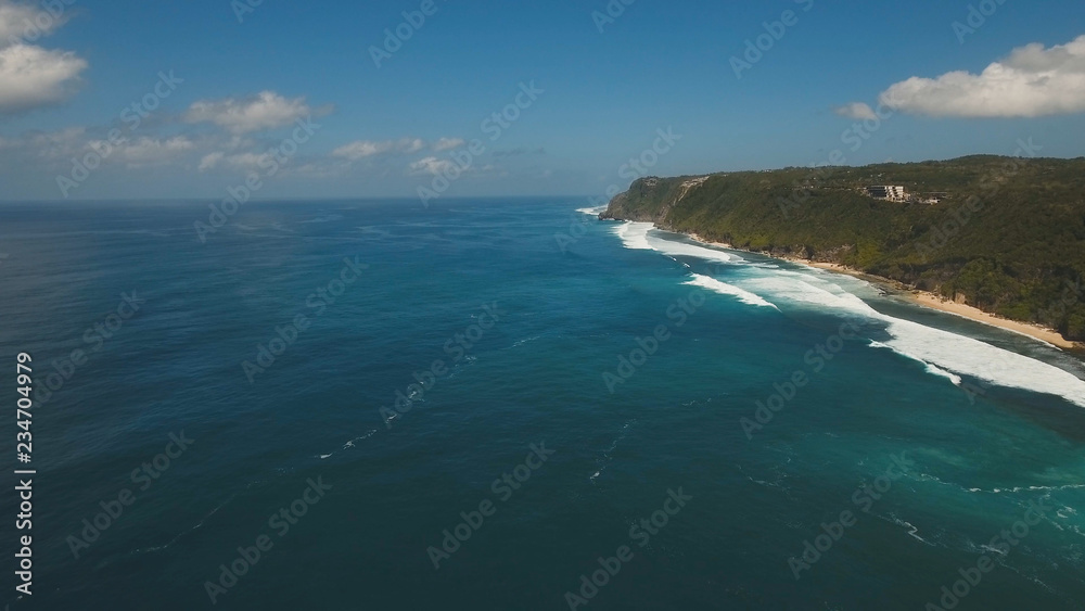 Aerial view of tropical beach with large wave. Large waves of turquoise water crushing on a beach Melasti, Bali,Indonesia. Travel concept.