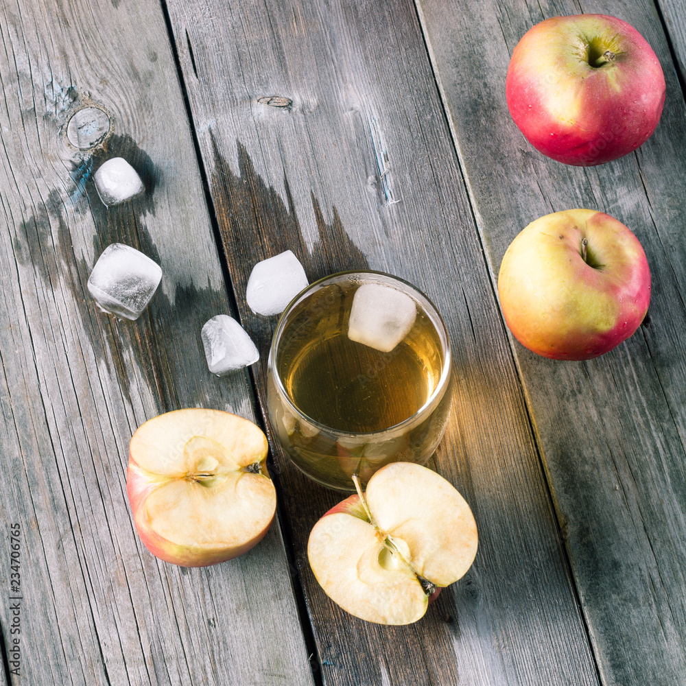 Some apples and a glass of fresh juice