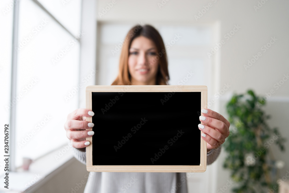 young woman holding black board young woman holding black board