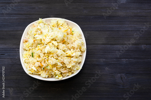 top view of Fried Rice in bowl on dark table