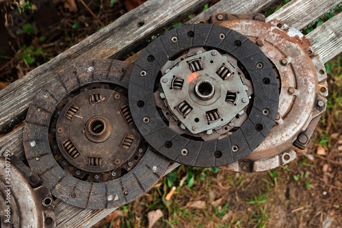 Clutch discs on a wooden background, car repair. © Aliaksandr Marko