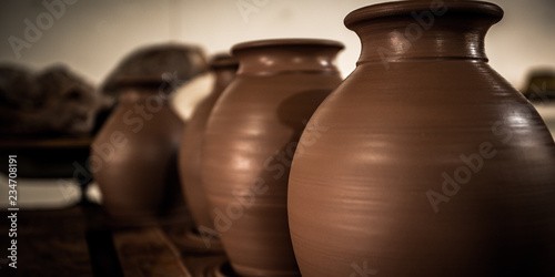 New brown clay pots drying on a table