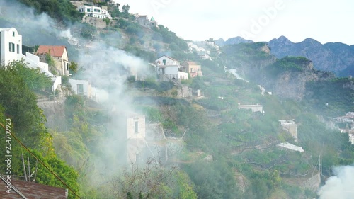 Amalfi, Amalfi Coast, Salerno, Italy. View of the mountains, village houses, coastline and the sea in the fog