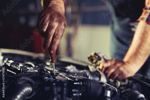 Worker repairs a car in a car repair center © zorandim75
