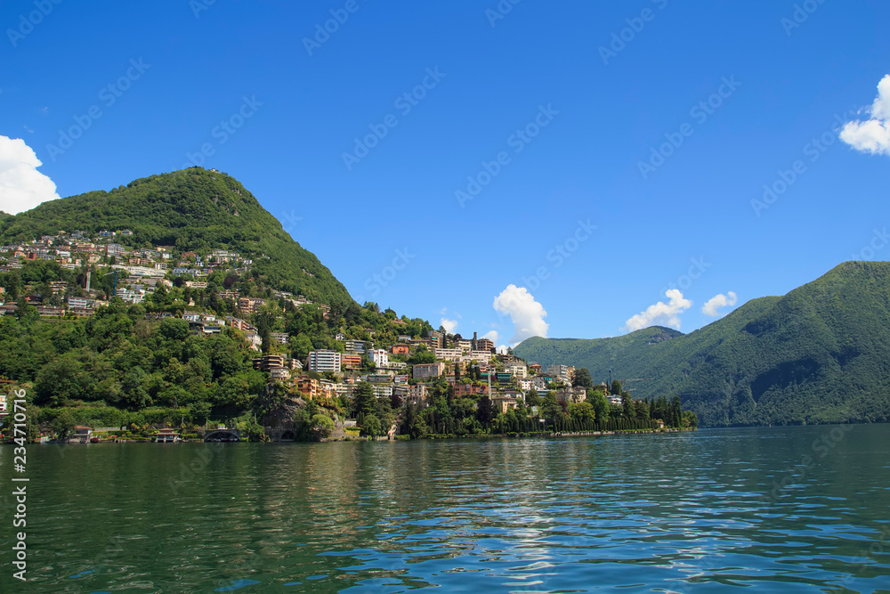 View of the houses of Lugano from the ship. Lake Lugano, Ticino,