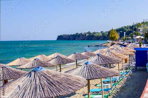 Umbrellas with loungers placed next to the coastline