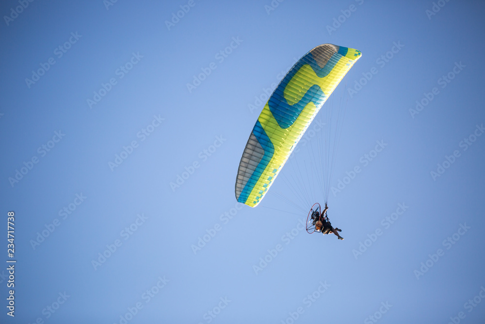 Hang-glider enjoying his flight in the sky, extreme sports Hang-glider enjoying his flight in the sky, extreme sports