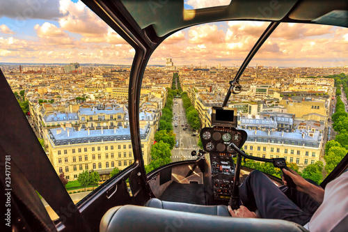 Helicopter cockpit flying on Paris skyline of the French capital, Europe. Scenic flight above Place de l'Etoile and Avenue de Wagram road of Paris skyline at sunset. photo