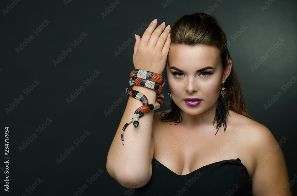 Perfect portrait sensual woman and king snake in the studio.