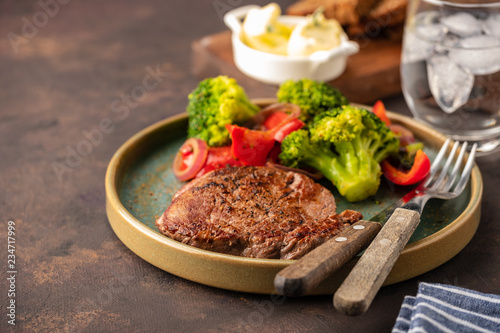 Grilled Beef steak with vegetables. Meat with grilled bell pepper, broccoli and onions