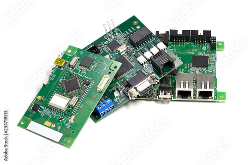 Set of electronic printed circuit boards with microchips, leds and other components, angled view, isolated on white