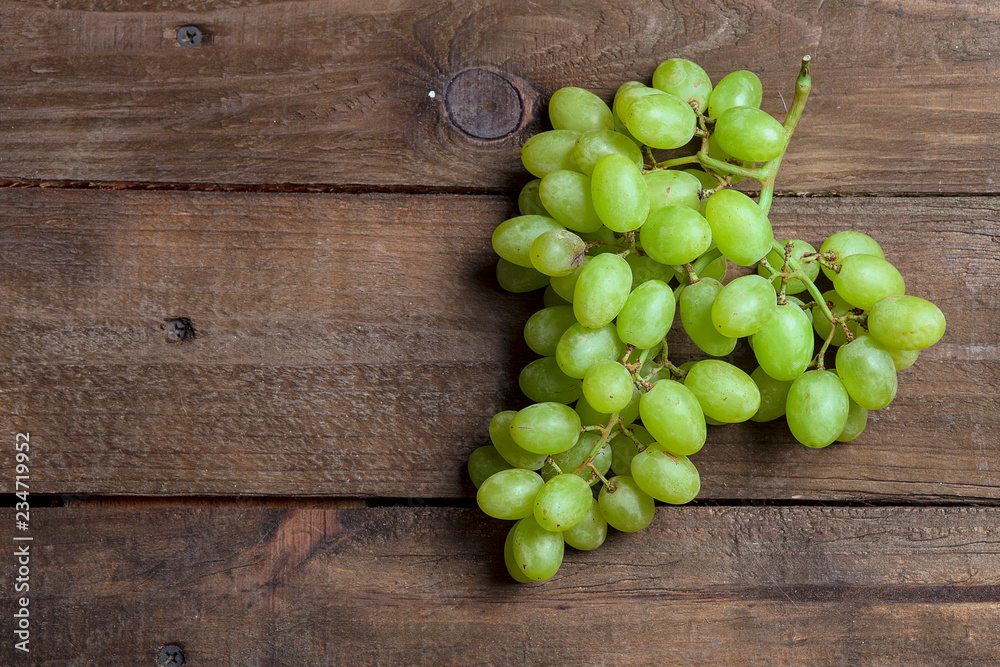 Bunch of grapes on wooden background Bunch of grapes on wooden background