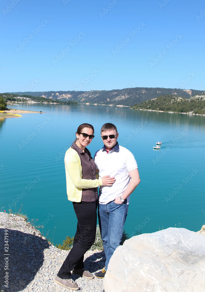 Rear view of a romantic young couple enjoying beautiful lake Verdon. Provance.