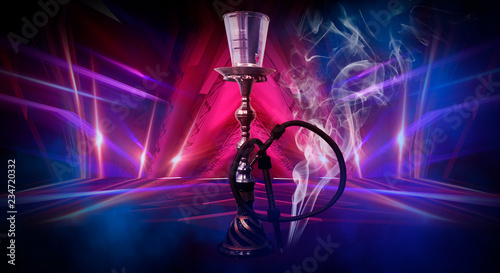 Hookah on an abstract neon background with smoke.