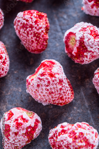 Close-up frozen strawberries covered by frost.