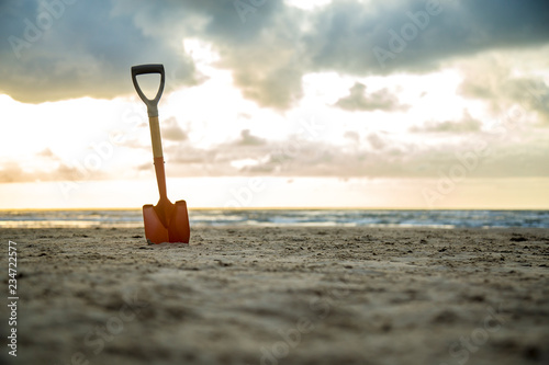 shovel in the sand of the beach photo
