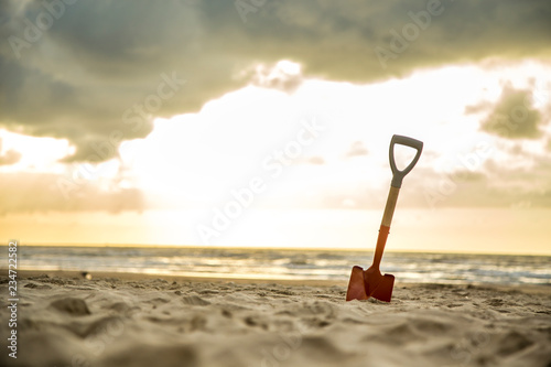 shovel in the sand of the beach