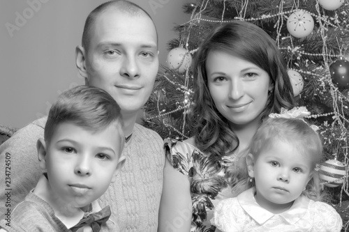Big happy family with children near the Christmas tree.