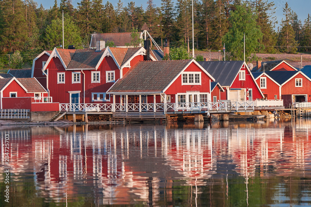 red houses at sunset in the fishing village of Norfaellsviken, Höga Kusten, Sweden red houses at sunset in the fishing village of Norfaellsviken, Höga Kusten, Sweden