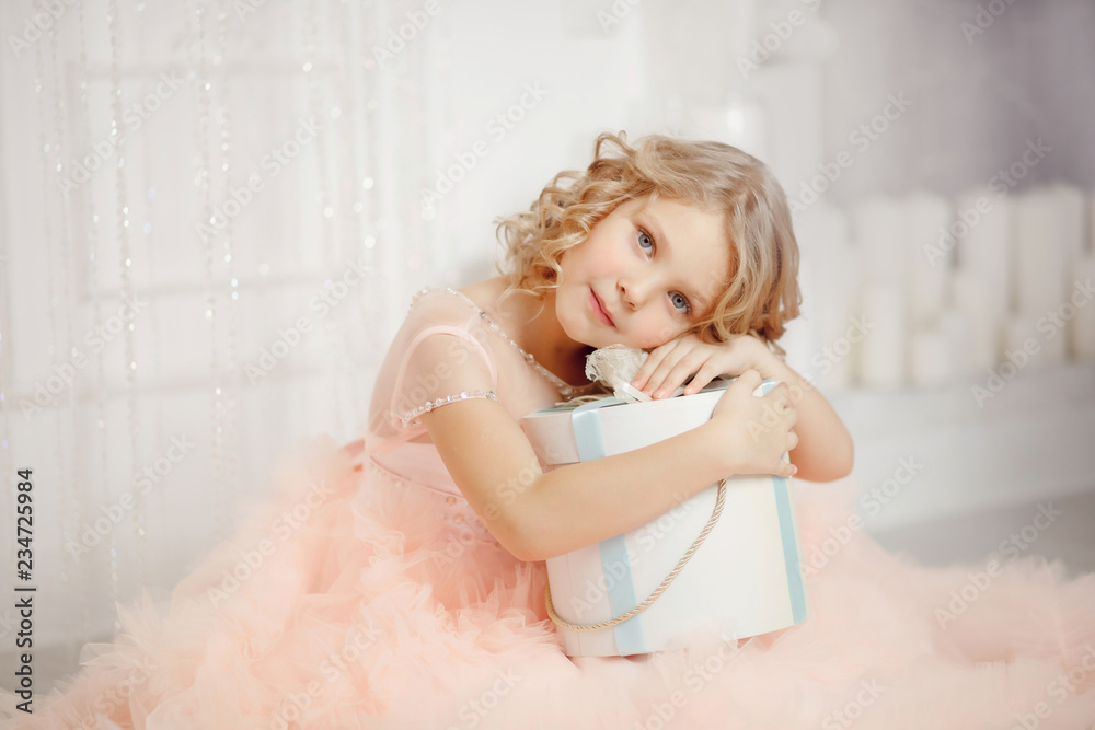 child girl in Santa hat opening Christmas New Year gift box child girl in Santa hat opening Christmas New Year gift box