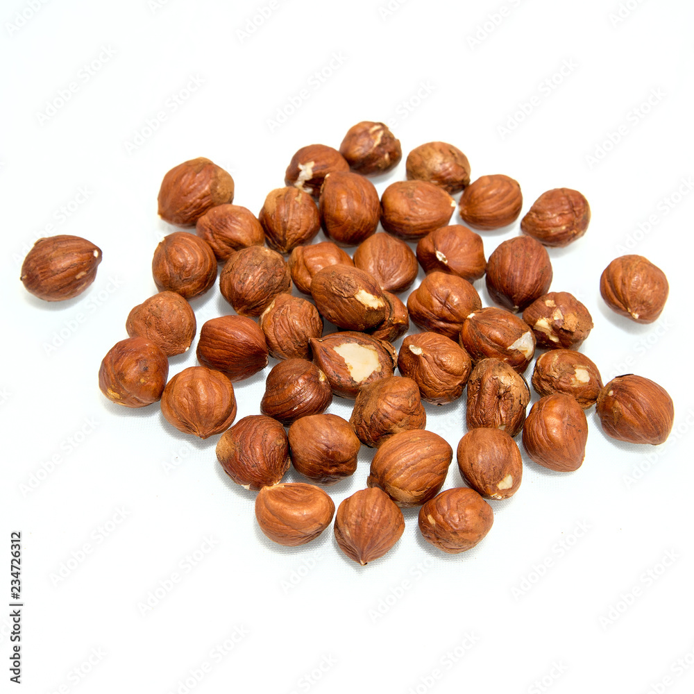 Unshelled hazel nuts isolated on white, food background. hazelnuts on a white background Unshelled hazel nuts isolated on white, food background. hazelnuts on a white background