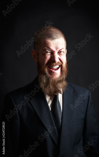 man screams with beard on a blue background, portrait