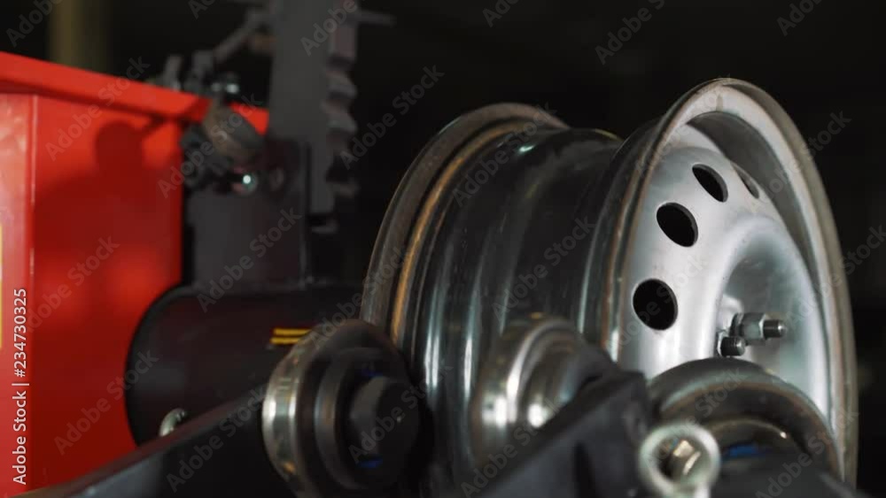 Equipment for car service and repair - tire machine for rolling and alignment of steel wheel rims close-up Equipment for car service and repair - tire machine for rolling and alignment of steel wheel rims close-up