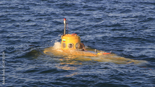 Obraz na plátne A shot of a small yellow submarine is resurfacing