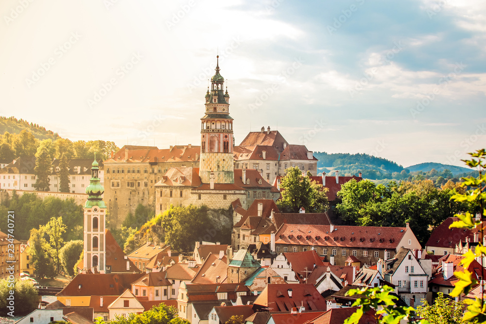 Cesky Krumlov castle tower, UNESCO, Czech Republic. Sunset aerial view of the old town architecture with red rooftops and tower.