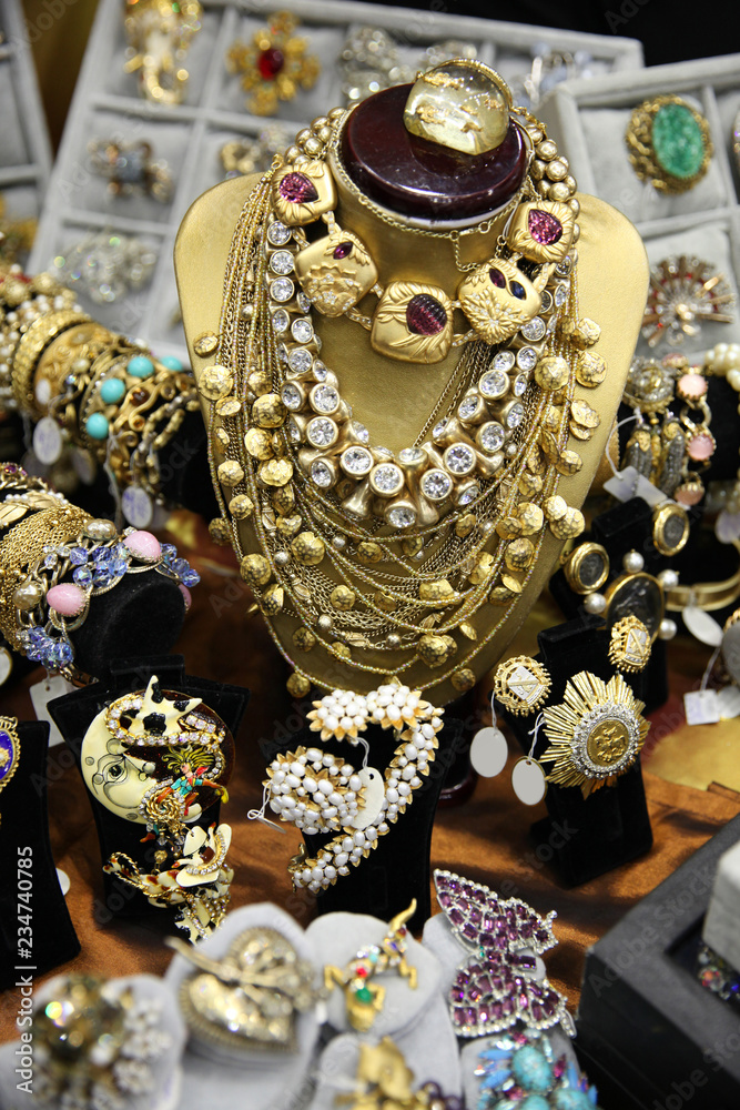 Large number of vintage jewelry, necklaces and brooches in gold color