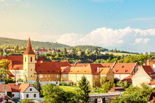 Cesky Krumlov, UNESCO, Czech Republic. Sunset aerial view of the old town architecture with red rooftops and houses. © plusminus20