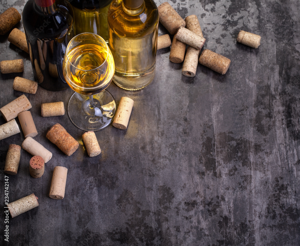 wine bottles , glass and corks on table