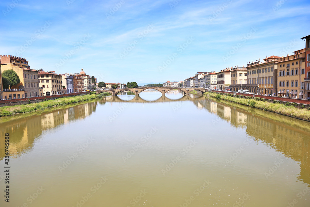 landscape of Florence or Firenze city Italy with impressive water reflections of the buildings on Arno river