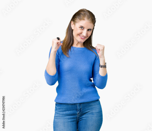 Beautiful middle age mature woman wearing winter sweater over isolated background looking confident with smile on face, pointing oneself with fingers proud and happy.