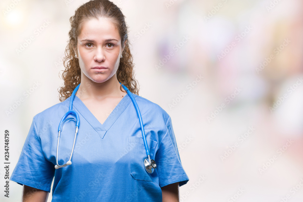 Young brunette doctor girl wearing nurse or surgeon uniform over isolated background with serious expression on face. Simple and natural looking at the camera. Young brunette doctor girl wearing nurse or surgeon uniform over isolated background with serious expression on face. Simple and natural looking at the camera.