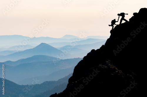 two climbers help scene, adventure and unusual diary photo