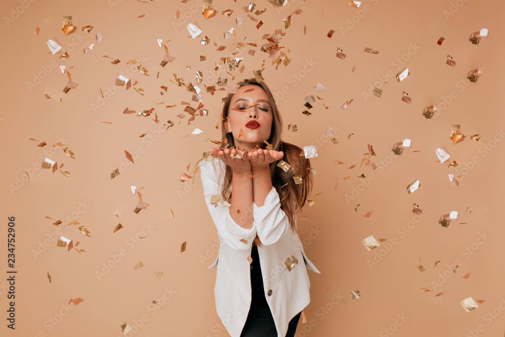 Portrait of happy lovely woman send a kiss to camera on isolated background with confetti. Happy celebration of new year, birthday - obrazy, fototapety, plakaty 