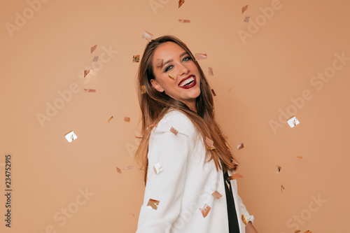 Happy lovely young lady smiling and having fun with lovely smile and champagne. Amazed glamorous girl with ginger hair having fun at christmas party.