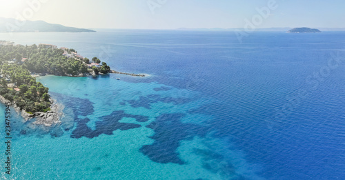 Wallpaper Mural Drone aerial view of sea shore on stones and blue water Torontodigital.ca