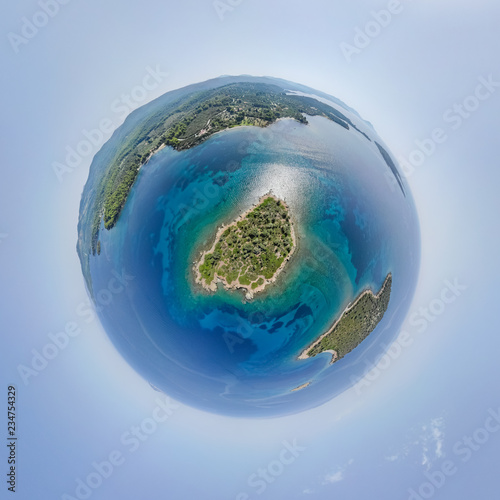 Little planet - spherical view above small island near the sea shore. 360 Drone aerial tiny planet