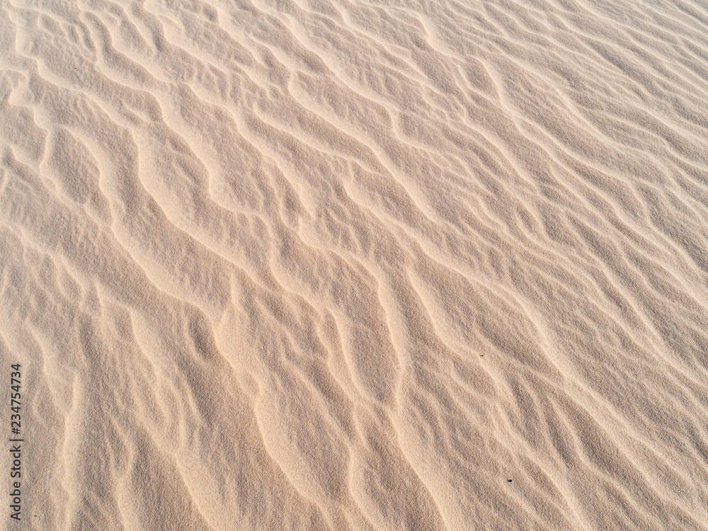 Beautiful structures of sandy dunes. sand with wave from wind in desert - Close up Beautiful structures of sandy dunes. sand with wave from wind in desert - Close up