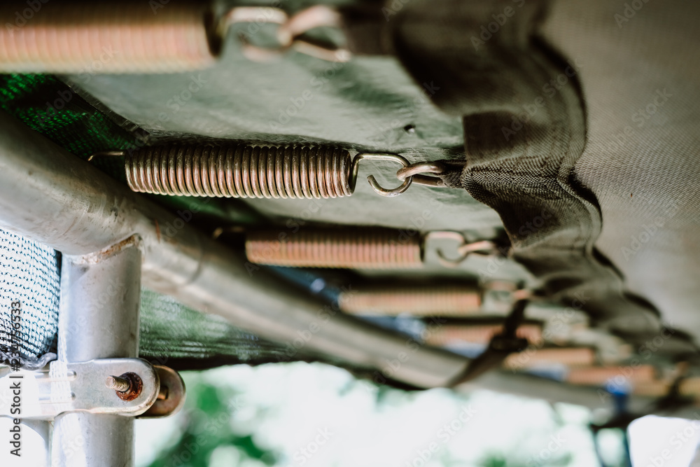 Obraz premium Close up of trampoline springs, bottom view