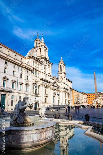 The Fontana del Moro, sculpted by Giacomo della Porta, in Piazza Navona, the ancient Stadium of Domitian, in Rome, Italy. Church of Sant'Agnese in Agone in the background.