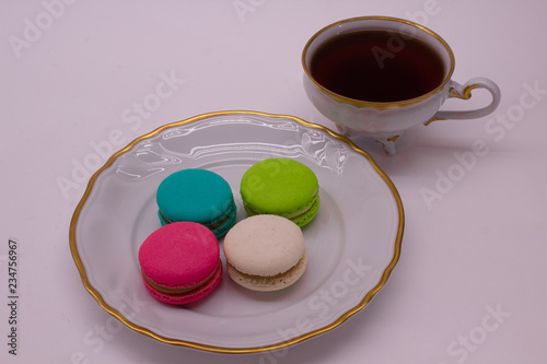 mug with tea and macaroons on a plate