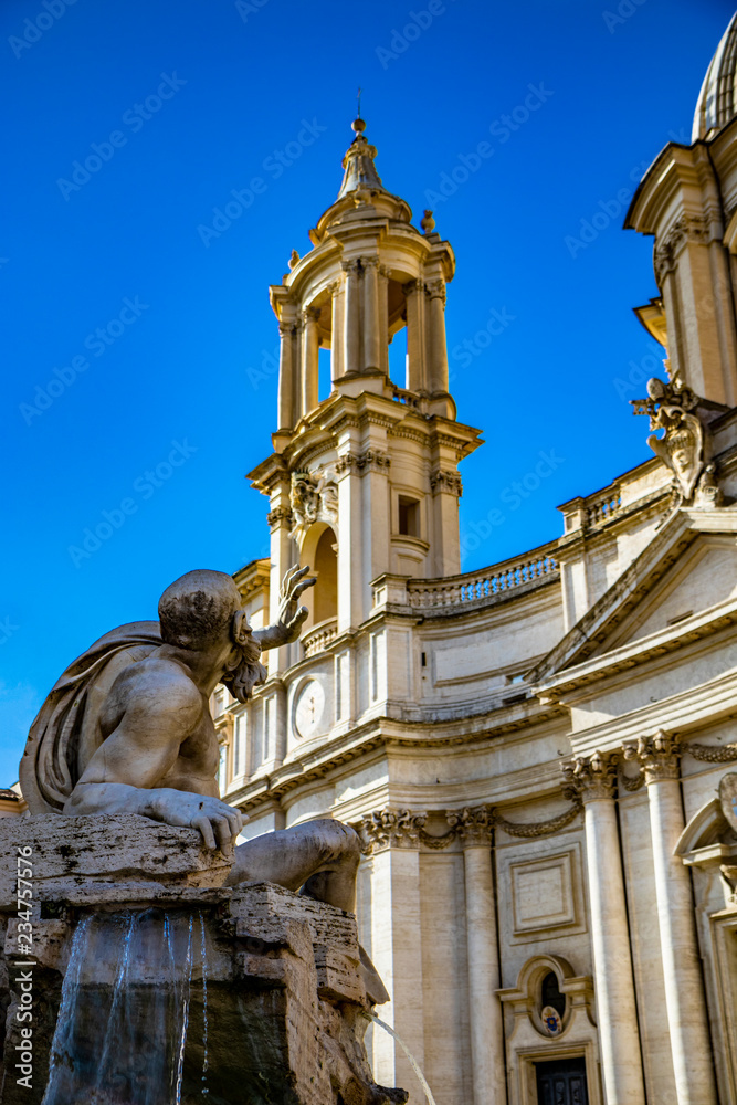 Closeup of the Rio de la Plata, in La Fontana Dei Quattro Fiumi designed by Gian Lorenzo Bernini, in Piazza Navona, Stadium of Domitian, in Rome, Italy. Church of Sant'Agnese in Agone in background