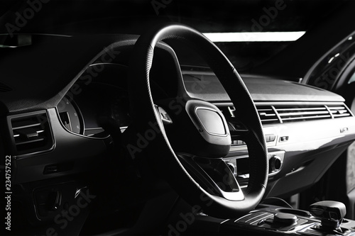 Modern luxury prestige car interior, dashboard, steering wheel. Black leather interior. © Dmitry Dven