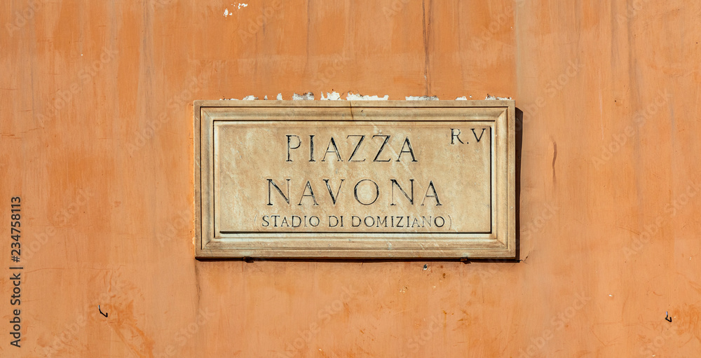 Street sign in Piazza Navona, Rome, Italy. Typical marble plaque of Rome, which indicates the name of the street or of the square, in the Italian capital. Navona square.