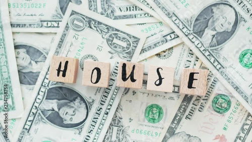 Wallpaper Mural rotating word house from wooden letters, on dollars, concept Torontodigital.ca